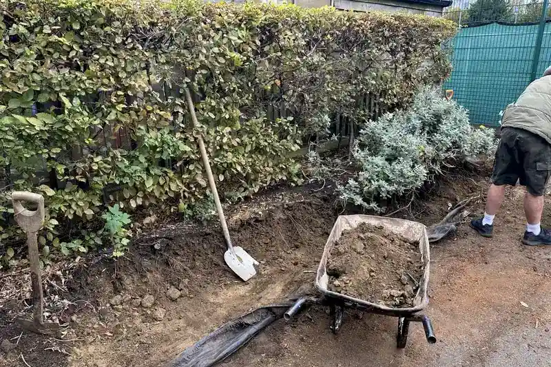 Garden clearance Herne Bay — overgrown bed stripped back and roots dug out leaving clean compacted base ready for type 1 path sub-base | mitchhandyman.co.uk