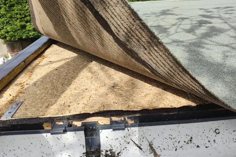 Flat roof felt peeled back to inspect OSB deck underneath — Mitchell Hunter Handyman, Herne Bay | mitchhandyman.co.uk