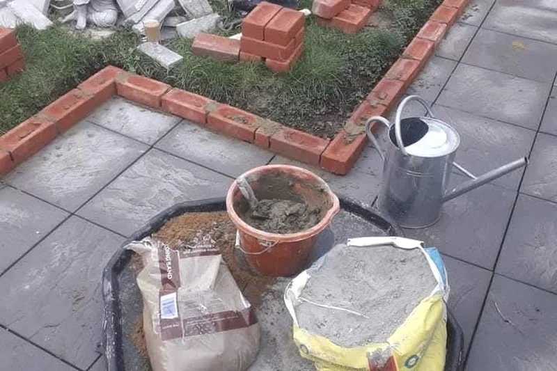 Garden brick edging being laid around lawn border — Mitchell Hunter Handyman, Whitstable | mitchhandyman.co.uk