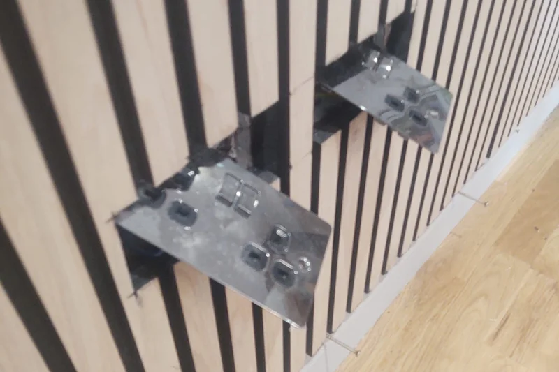 Steel shelf brackets fitted through slatted wall panel — Mitchell Hunter Handyman, Herne Bay | mitchhandyman.co.uk