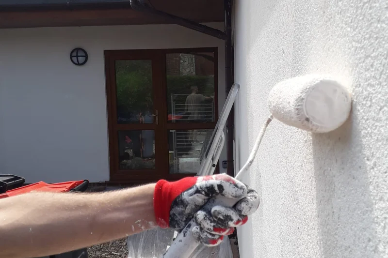 Exterior render being painted with roller — Mitchell Hunter Handyman, Herne Bay | mitchhandyman.co.uk