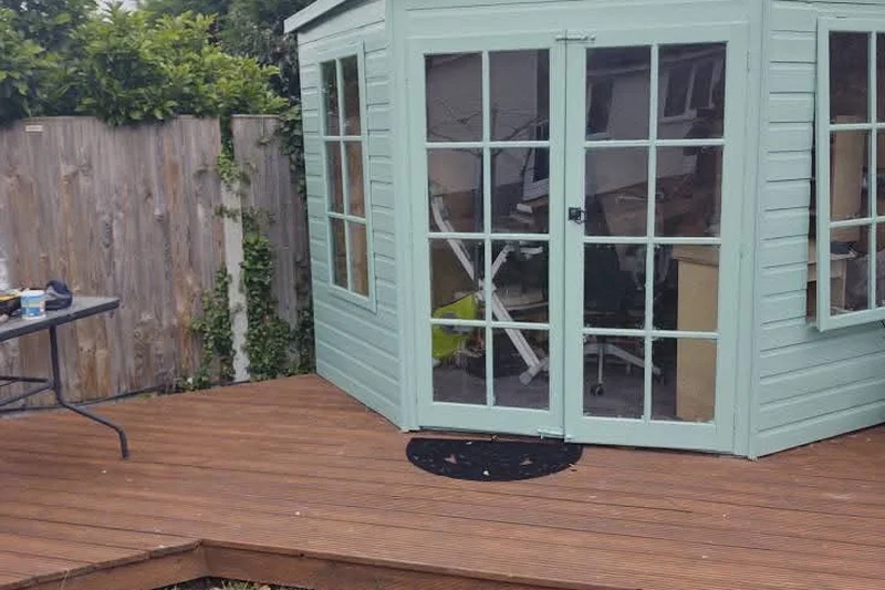 Garden summerhouse fully repainted in sage green with restored decking — Mitchell Hunter Handyman, Blean | mitchhandyman.co.uk