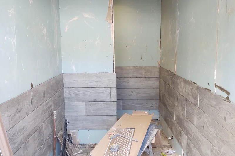 Bathroom before retiling, bare walls and concrete floor — Mitchell Hunter Handyman, Herne Bay | mitchhandyman.co.uk