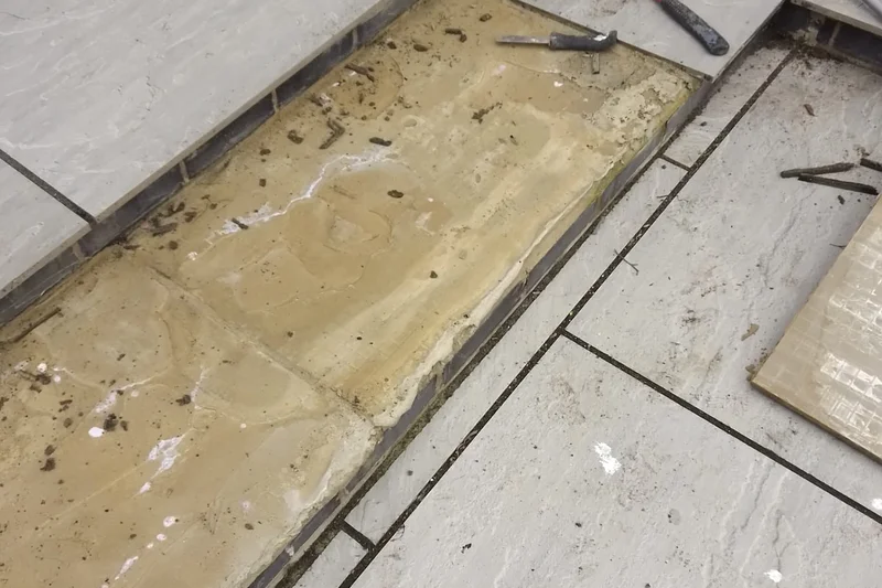 Patio stone tile lifted for repair, mortar bed exposed — Mitchell Hunter Handyman, Chestfield | mitchhandyman.co.uk